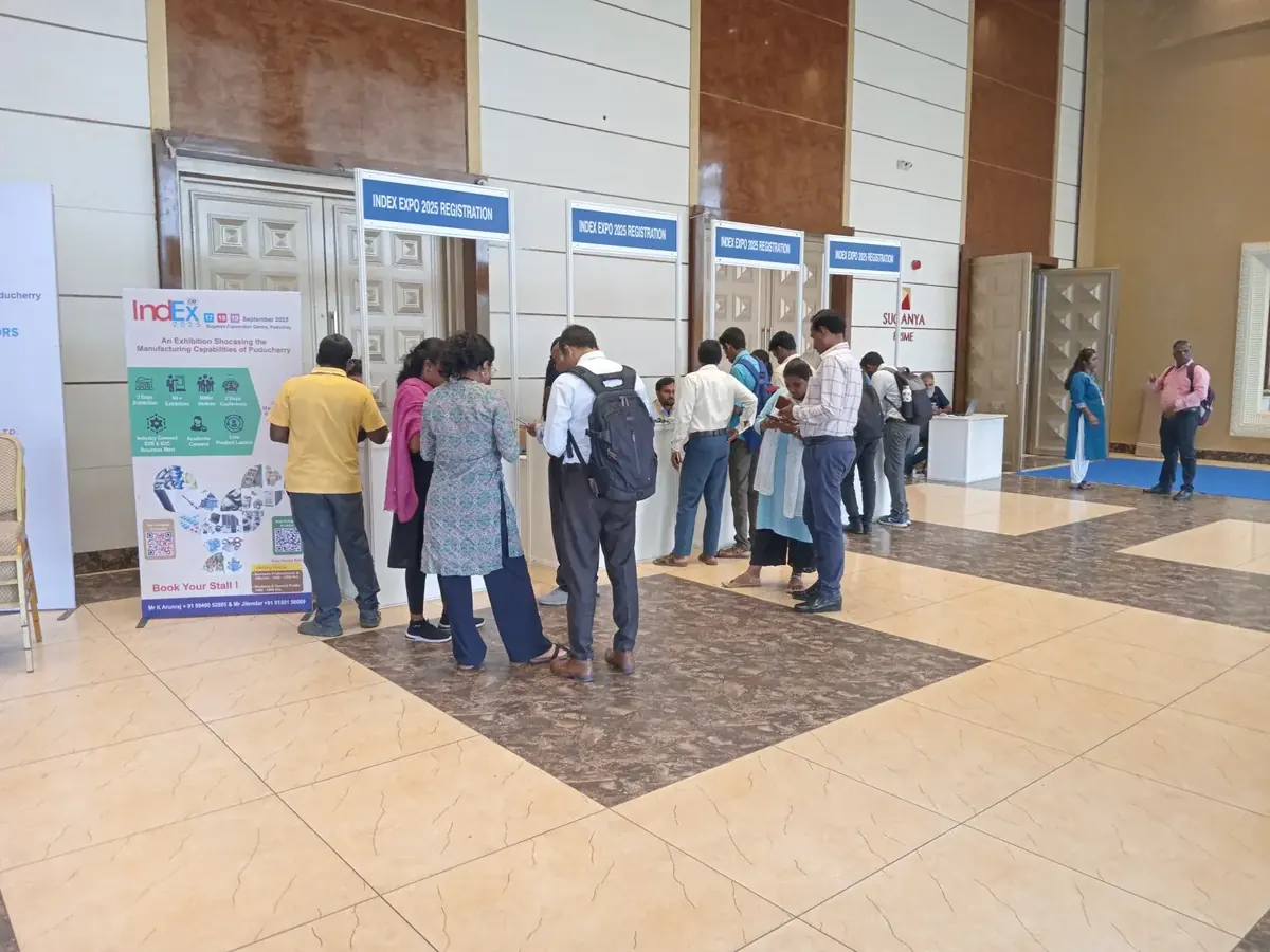 Exhibition registration desks with visitors at Suganya Convention Centre, Pondicherry