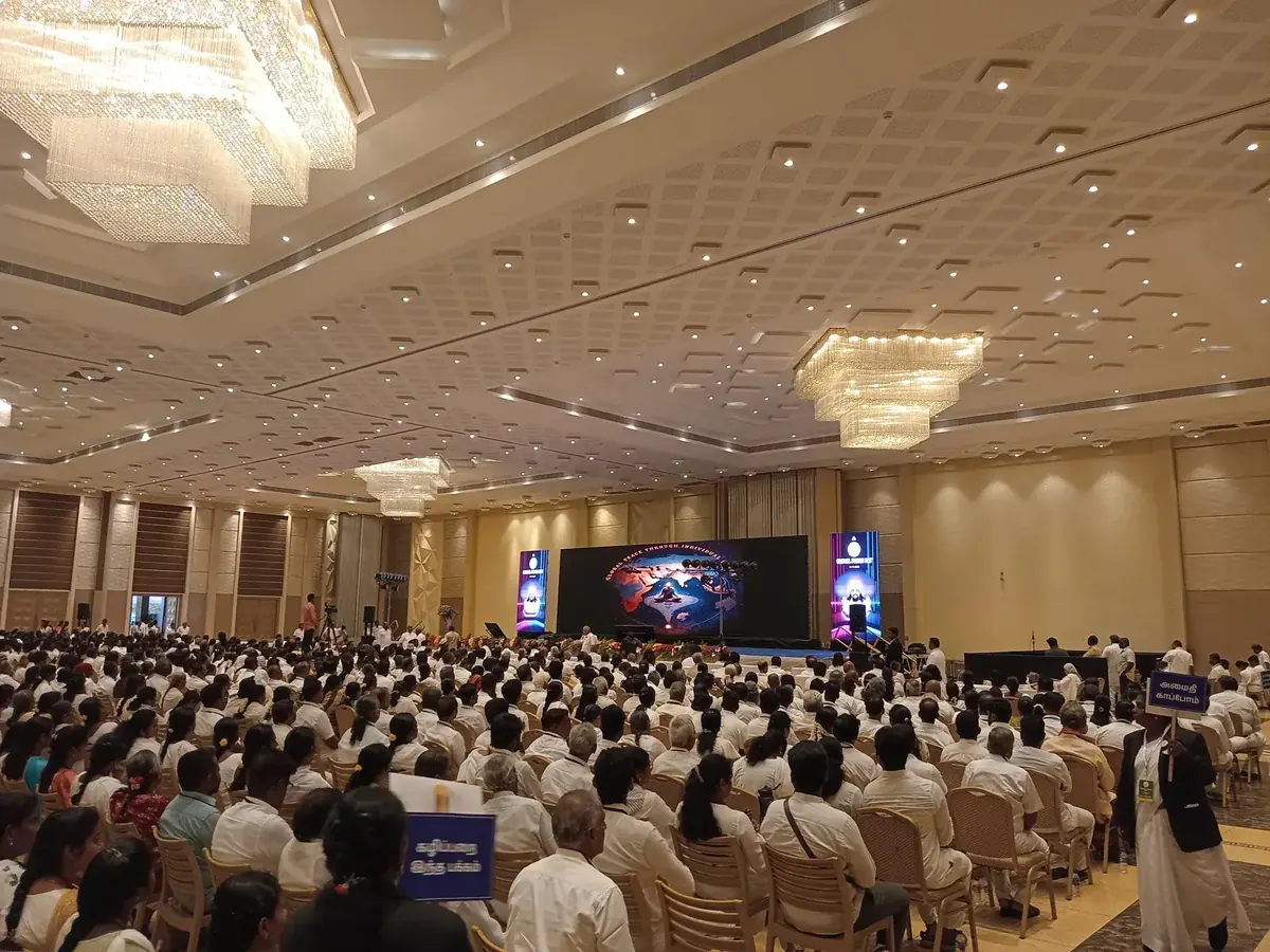 Seated audience at a public address in the main hall at Suganya Convention Centre, Pondicherry