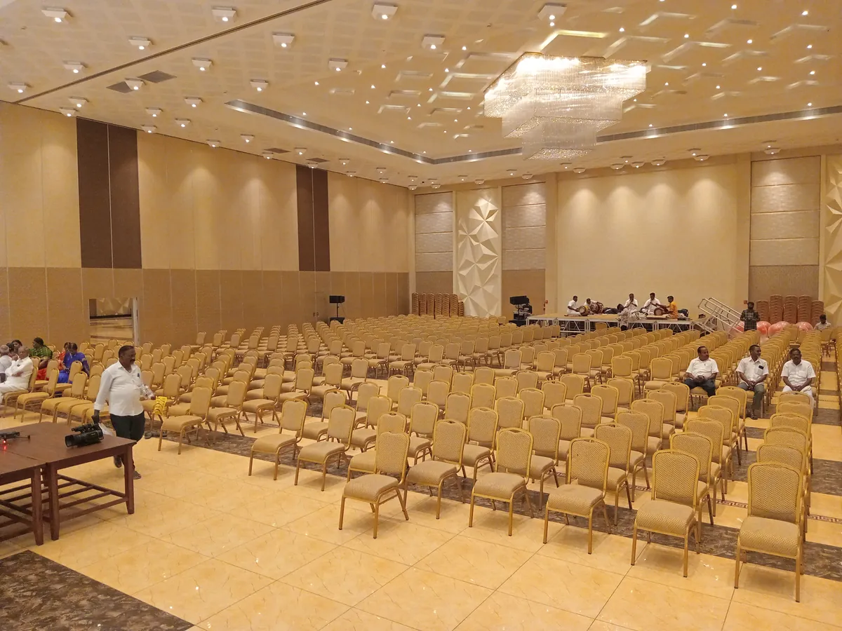 Wedding hall in Pondicherry arranged with banquet seating for 1,100 guests facing a floral stage