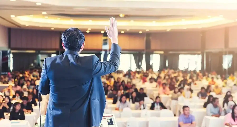 Keynote speaker addressing a packed corporate audience at Suganya Convention Centre, Pondicherry