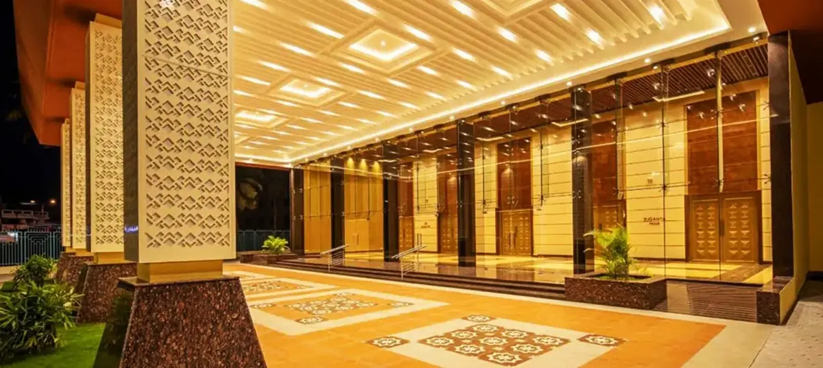 Illuminated exterior of Suganya Convention Centre, an award-winning wedding and event venue on 100 Feet Road, Pondicherry, at dusk